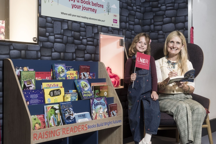 Cressida-Cowell-with-the-Raising-Readers-Book-Nook-at-Edinburgh-Waverley-Station-scaled.jpeg