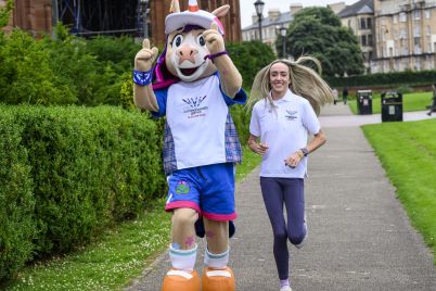 Eilish-McColgan-runs-with-Glasgow-2026-mascot-Finnie-scaled.jpg